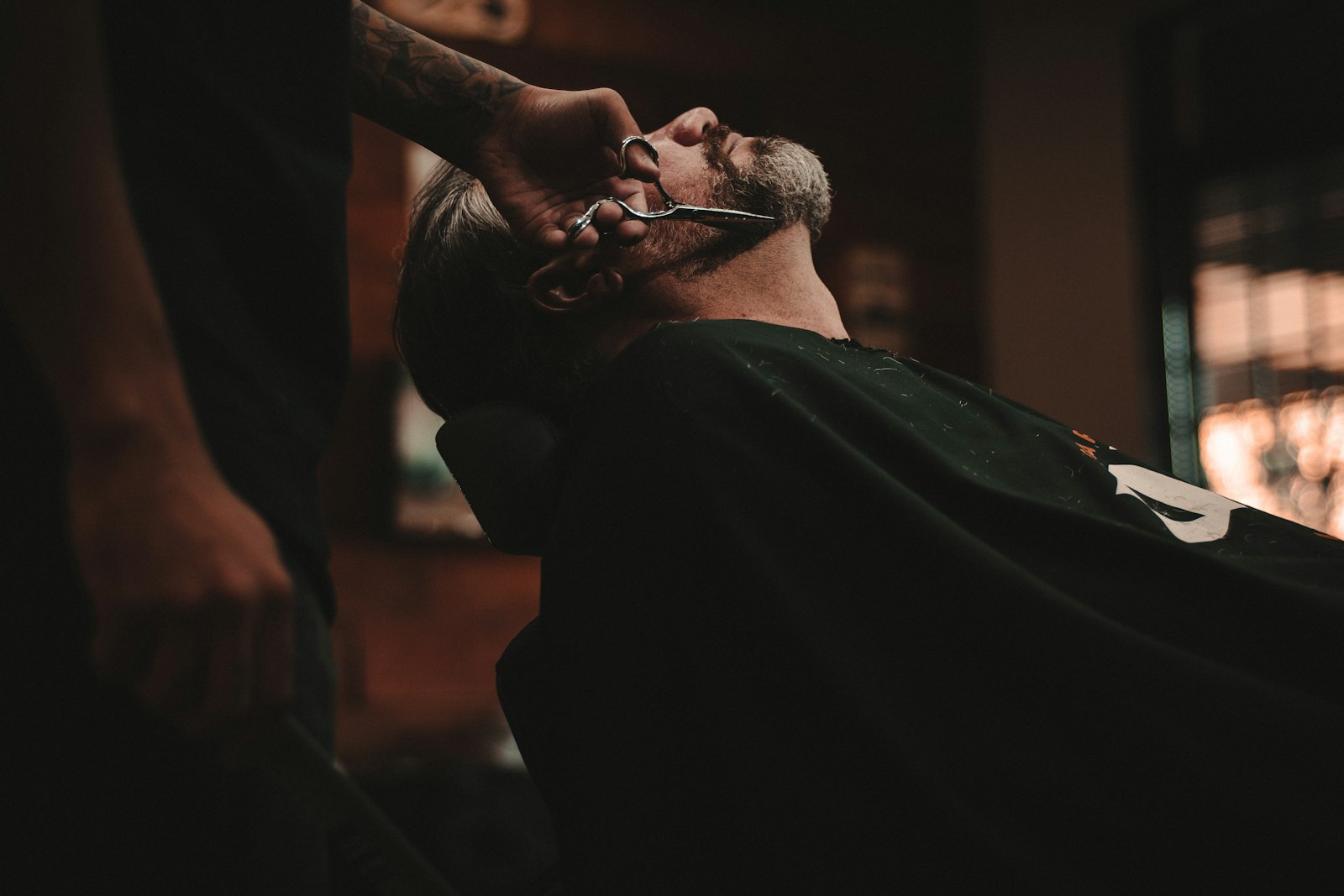Barber at work under low light